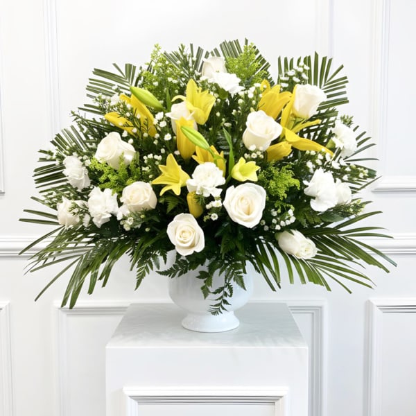 White roses and yellow lilies in a white vase
