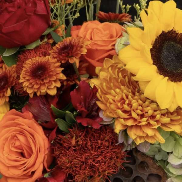 Bouquet of sunflowers, roses, and orange chrysanthemums