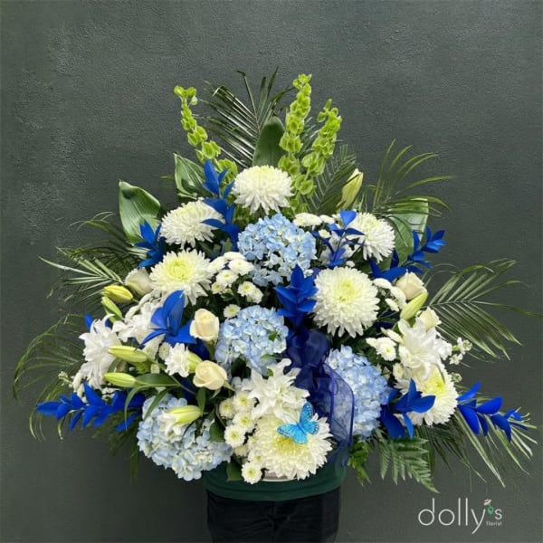 Large blue and white floral arrangement with hydrangeas and chrysanthemums