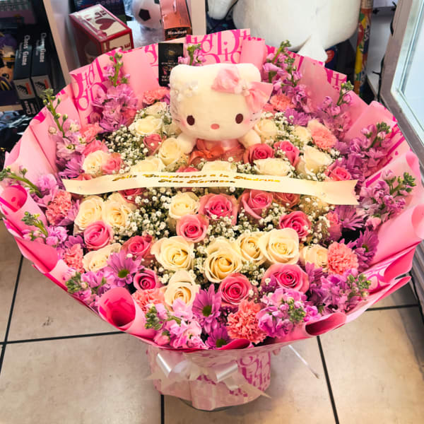 Pink and cream rose bouquet with a Hello Kitty plush centerpiece