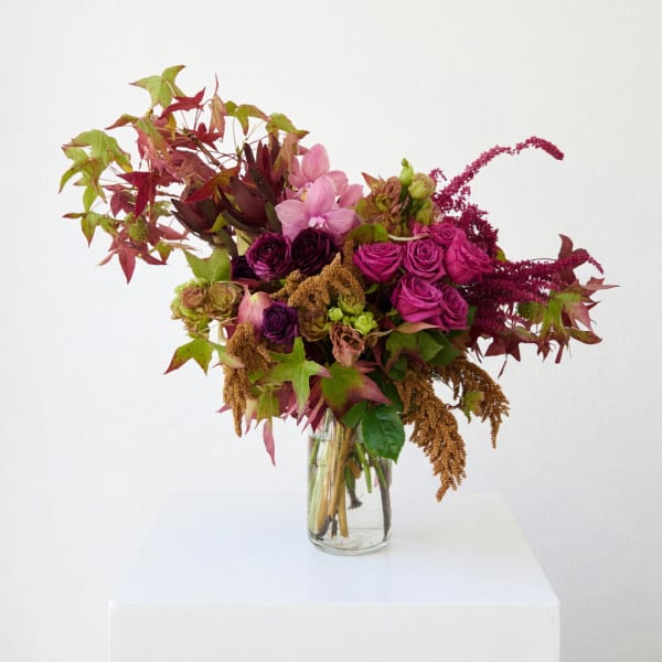 Mixed pink and purple bouquet in a clear glass vase