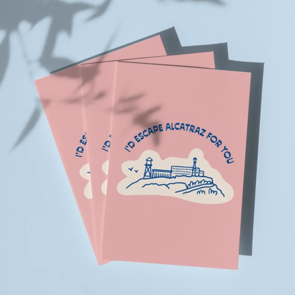 Three pink greeting cards with an Alcatraz illustration and blue text