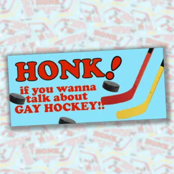 A printed sign with hockey sticks and bold text on a patterned background.