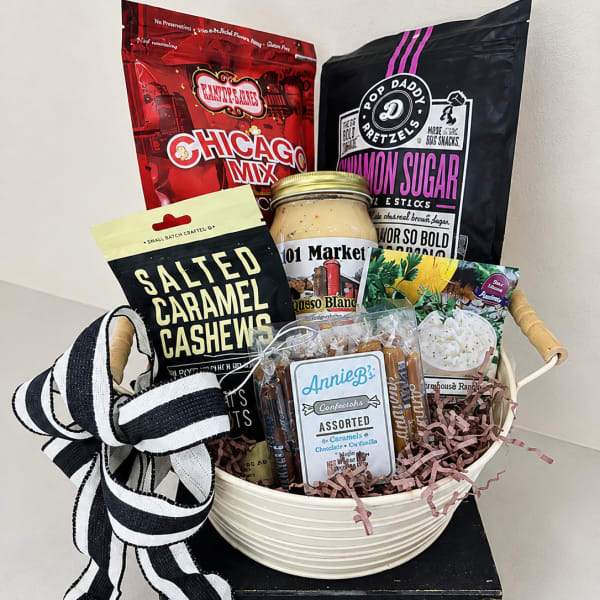 Gift basket with assorted snacks, candies, and a black-and-white ribbon bow