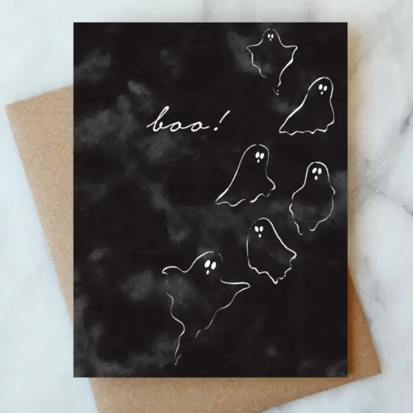 Black Halloween card with white ghost drawings and the word boo