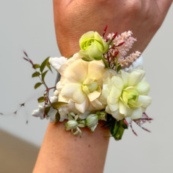 Wedding wrist corsage with pale cream and green flowers