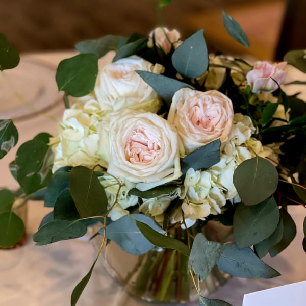 Bouquet of pale pink roses and white hydrangeas in a glass vase