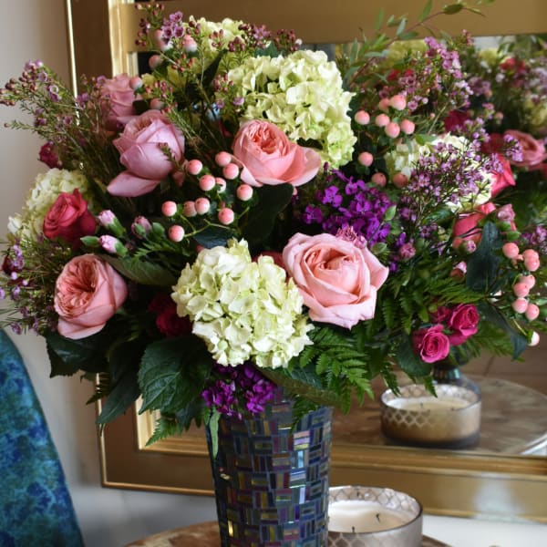 Pink roses and hydrangeas in a mosaic vase