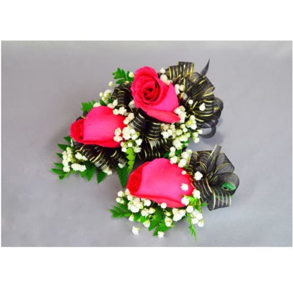 Three pink rose corsages with black ribbon accents