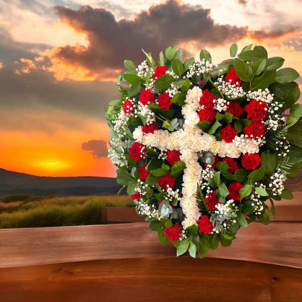 Heart-shaped floral arrangement with red and white flowers