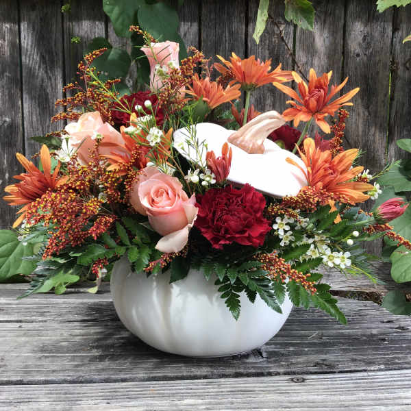 Pumpkin-shaped vase with orange and pink flowers