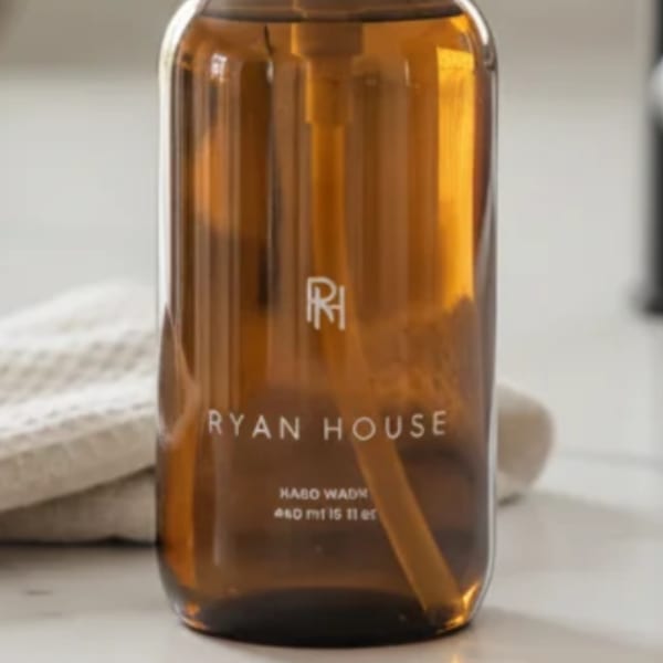 Amber glass bottle labeled Ryan House on a light surface