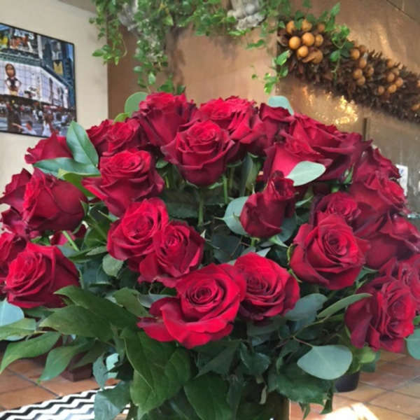 Large bouquet of red roses in a glass vase