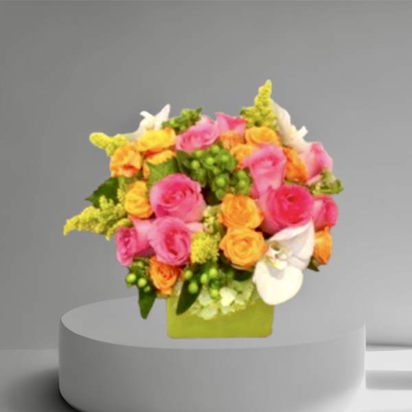 Colorful bouquet of pink and orange roses in a green square vase
