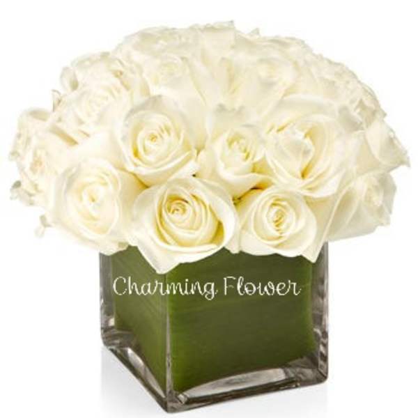 White rose bouquet in a square glass vase