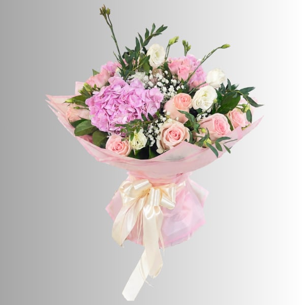 Pink and white bouquet with roses and hydrangea wrapped in pink paper