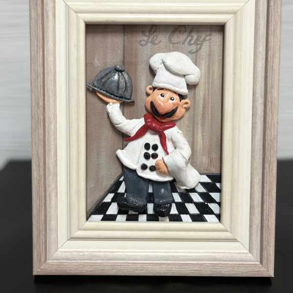 Framed chef figurine holding a serving tray