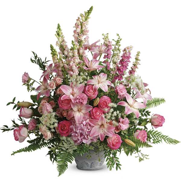 Pink lilies and roses arranged in a gray vase