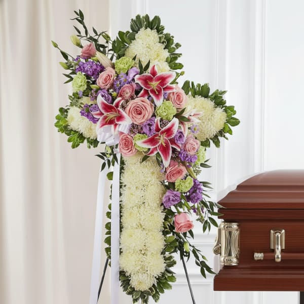 Standing funeral spray with pink lilies, roses, and white flowers