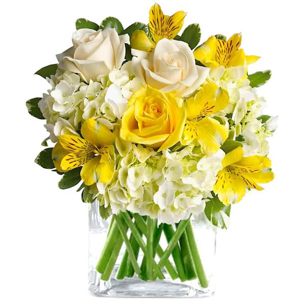 Yellow and white roses with hydrangeas in a clear glass vase