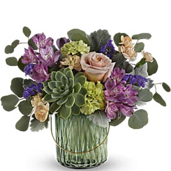 Mixed bouquet with a succulent and roses in a glass vase