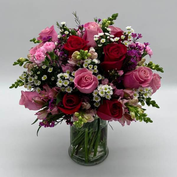 Bouquet of pink and red roses in a clear glass vase