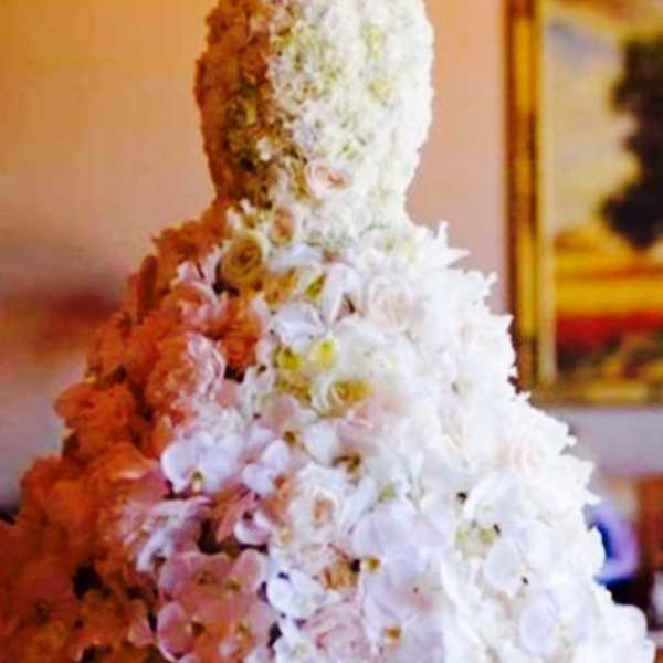 Tall tiered floral arrangement with white and pink flowers