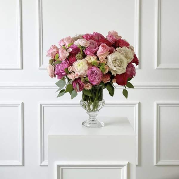 Pink and white rose bouquet in a clear glass vase