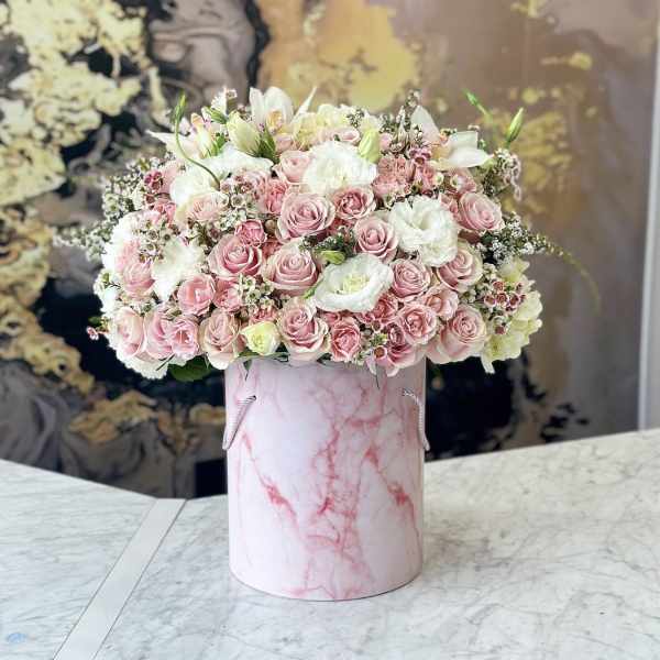 Pink and white rose arrangement in a pink marbled hatbox