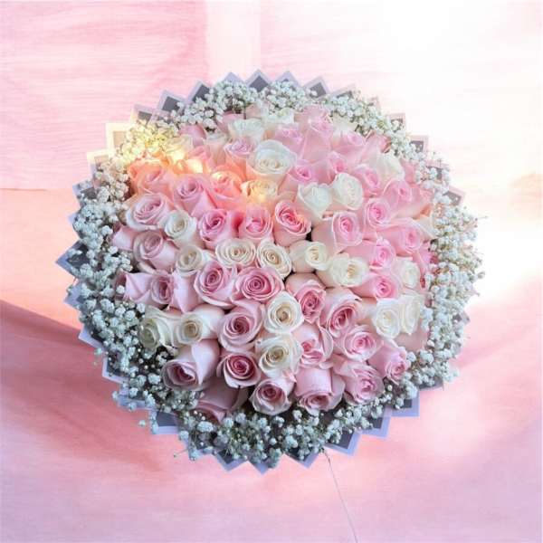 Large bouquet of pink and white roses with baby's breath