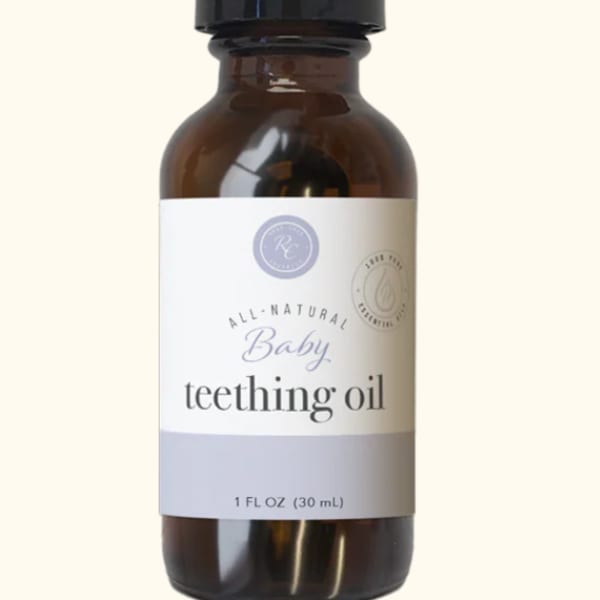 Amber bottle with black pump labeled baby teething oil