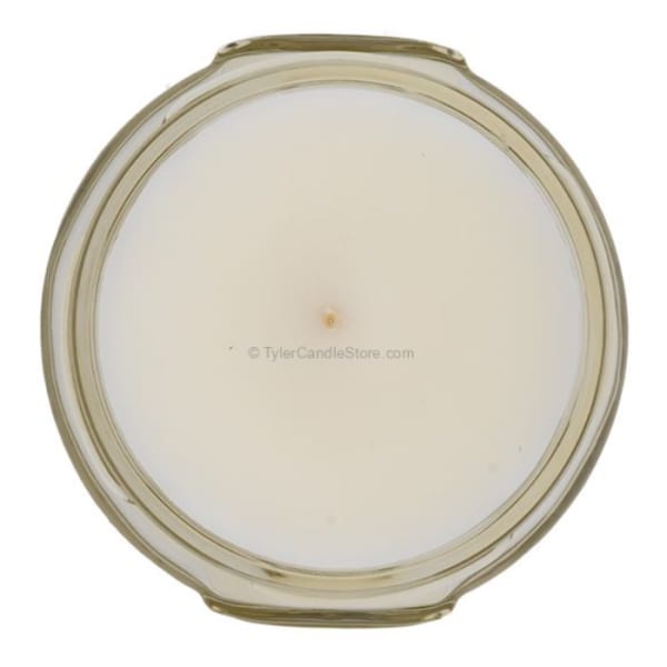 Round white candle in a clear glass jar
