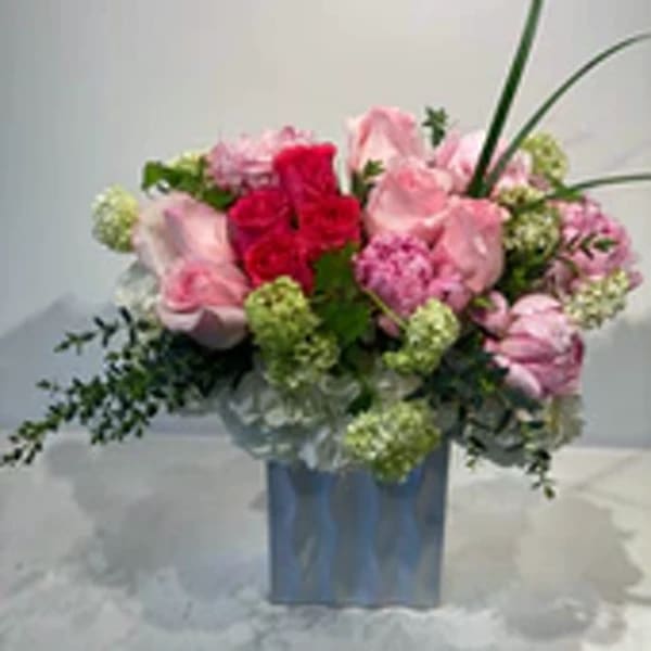 Pink and red rose bouquet in a blue vase