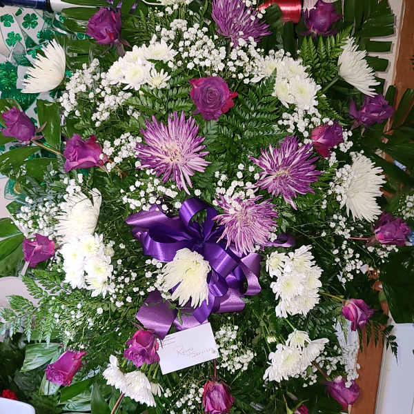 Purple and white funeral wreath with roses and chrysanthemums