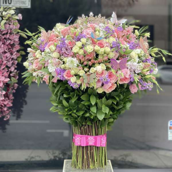 Large bouquet of pink and purple flowers with butterflies