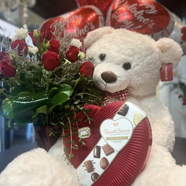 Red and white rose bouquet with a teddy bear, heart balloons, and a chocolate box