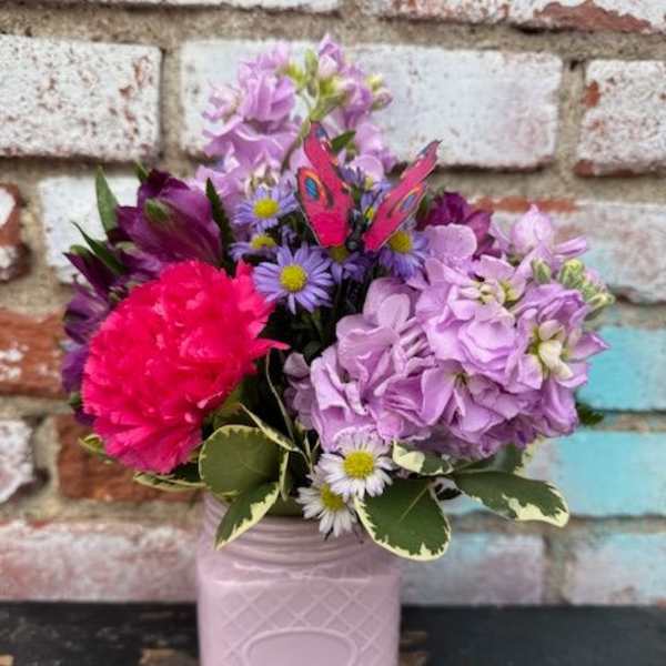 Pink and lavender bouquet in a pale pink vase