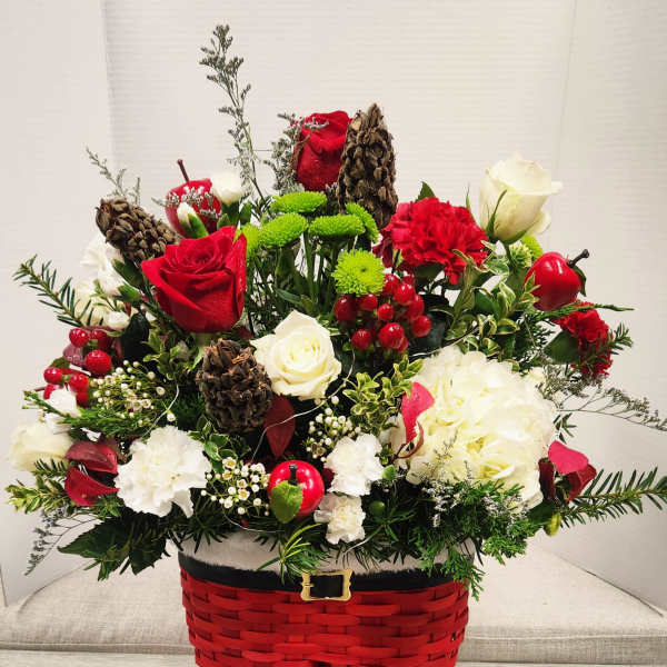Holiday floral arrangement in a red basket shaped like Santa pants