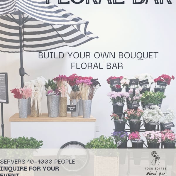 Mobile floral bar display with assorted flowers in buckets under a striped umbrella