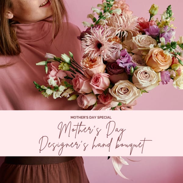 Hand-tied bouquet of pink and cream flowers with a ribbon