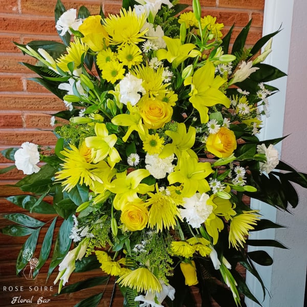 Yellow and white floral standing arrangement with lilies and roses