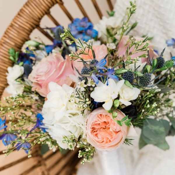 Hand-tied bouquet of pink, white, and blue flowers