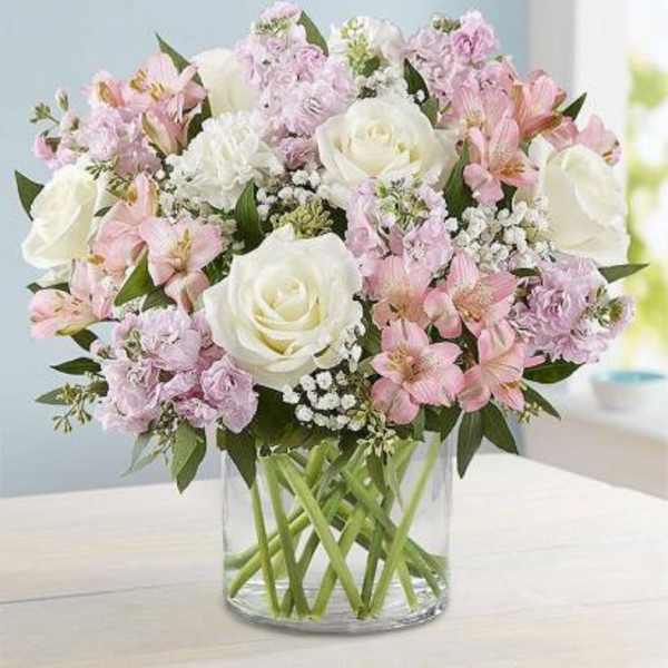 Pink and white bouquet in a clear glass vase
