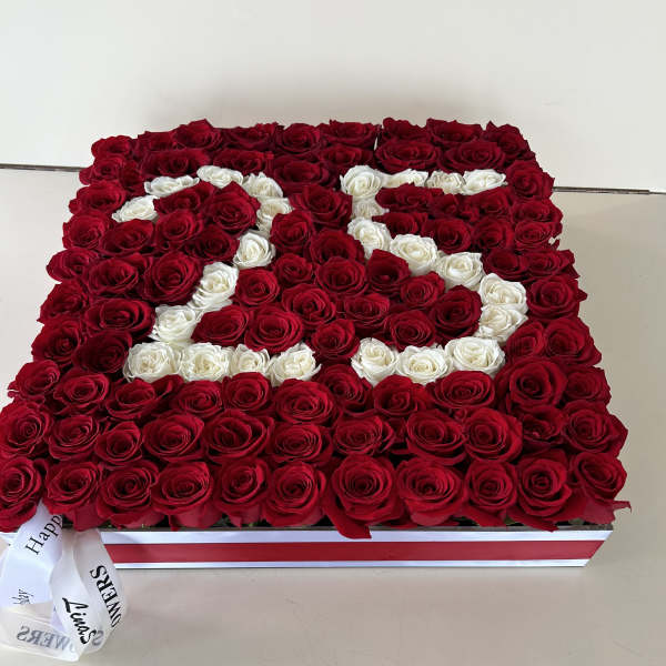 Rectangular box arrangement of red and white roses with a ribbon bow