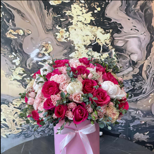 Pink and white rose bouquet in a pink hat box with ribbon