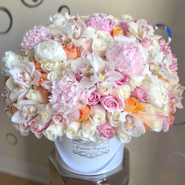 Large pastel bouquet of roses, orchids, and peonies in a white hat box