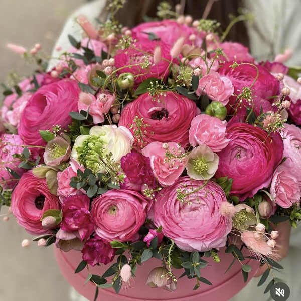 Pink ranunculus bouquet in a round pink box