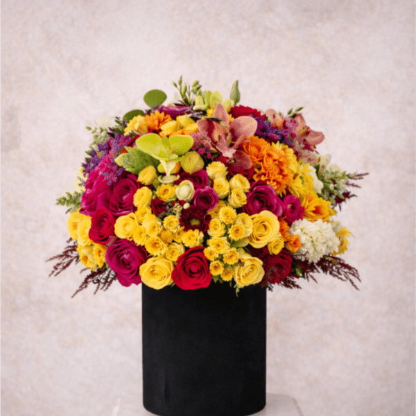 Bright mixed bouquet in a black cylindrical vase