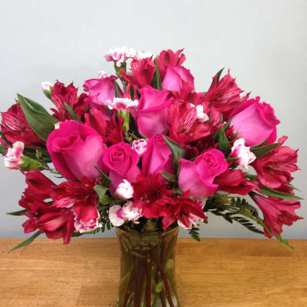 Pink roses and red alstroemeria in a glass vase