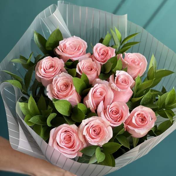 Bouquet of pink roses wrapped in striped paper